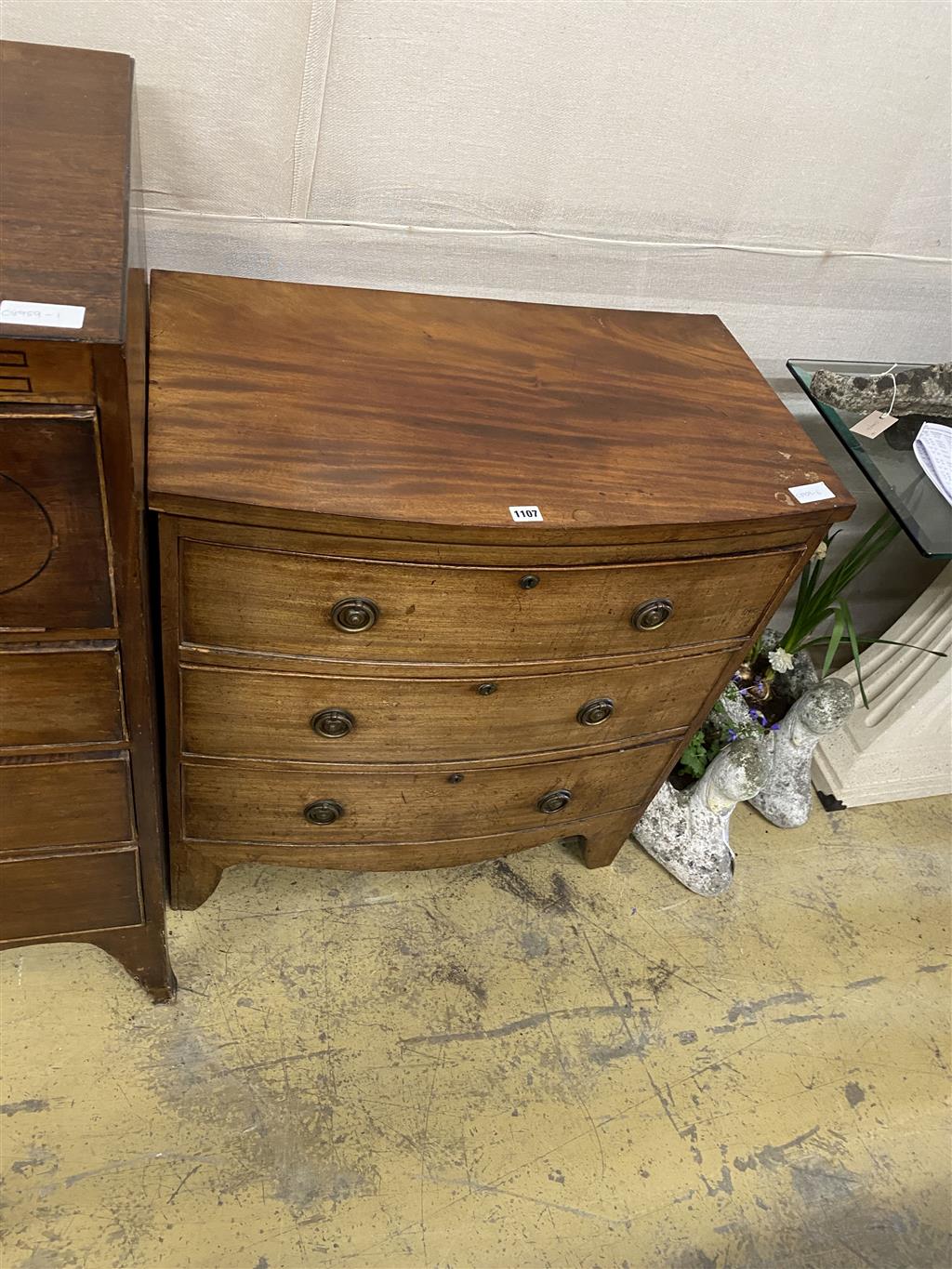 A small Regency mahogany bow fronted chest of drawers, width 75cm, depth 43cm, height 83cm together with an Edwardian banded mahogany b